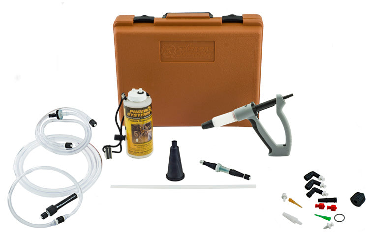 A brown, rectangular case is seen in the picture next to a number of instruments, including a bottle, hose, syringe, and different fittings. It's a brake and clutch bleeder kit for auto repairs.