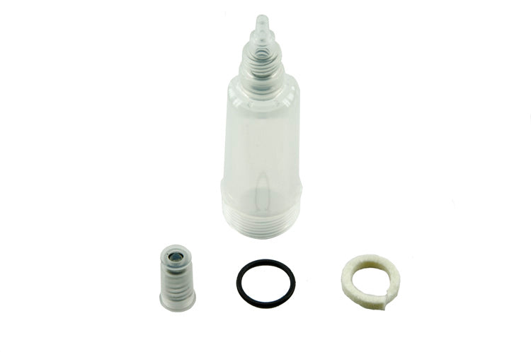 A clear plastic bottle with a black cap sits against a white background. Rubber rings of various sizes rest on the bottle's neck