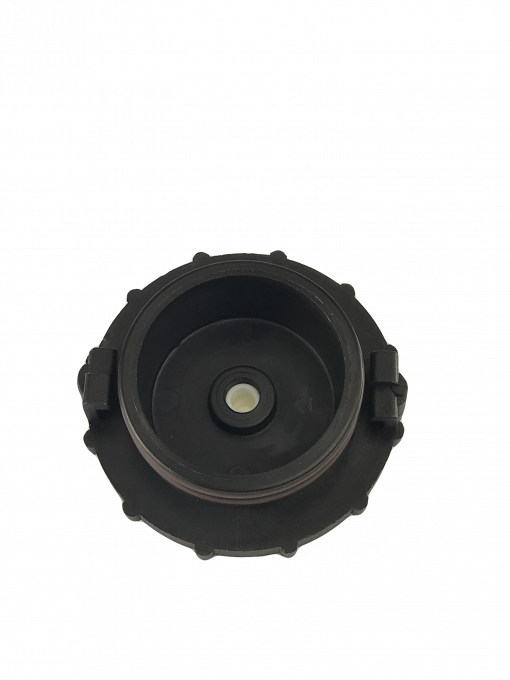 close-up of a black, circular object with a threaded hole in the center. It is centered on a gray background. The object appears to be made of metal and is  possibly a car part.  Specifically, it is a master cylinder brake bleeder adapter, a tool used to bleed the brakes on certain Honda vehicles.