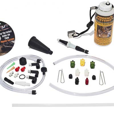 The image depicts a Phoenix Systems Brake Bleeding Kit Smart-Pak V-12, designed for one-person brake bleeding. It includes a clear plastic bottle with a black lid, a hose, and various adapters and connectors, all essential for the brake bleeding process.